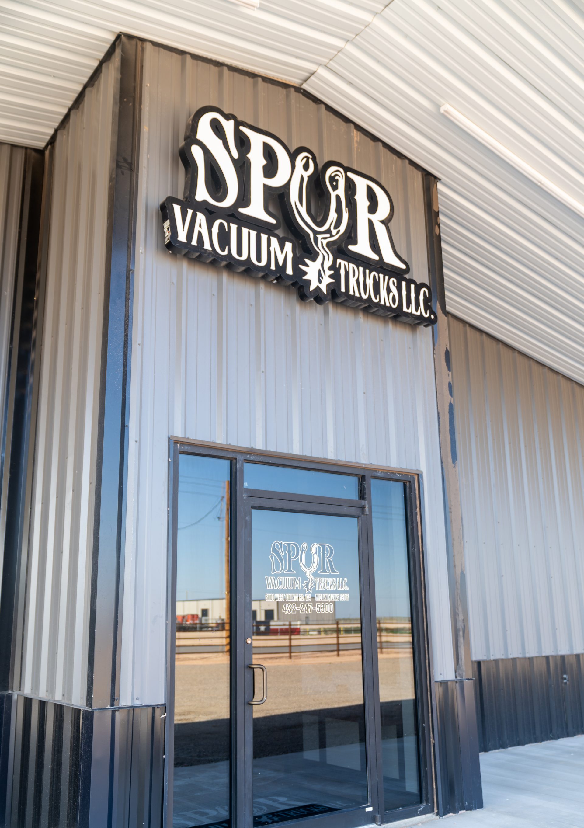 Spur Vacuum Trucks office entrance and front door signage in Midland